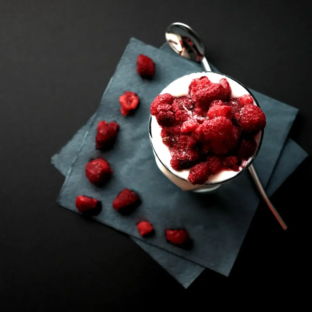 Bowl of cottage cheese with fresh fruits and honey.