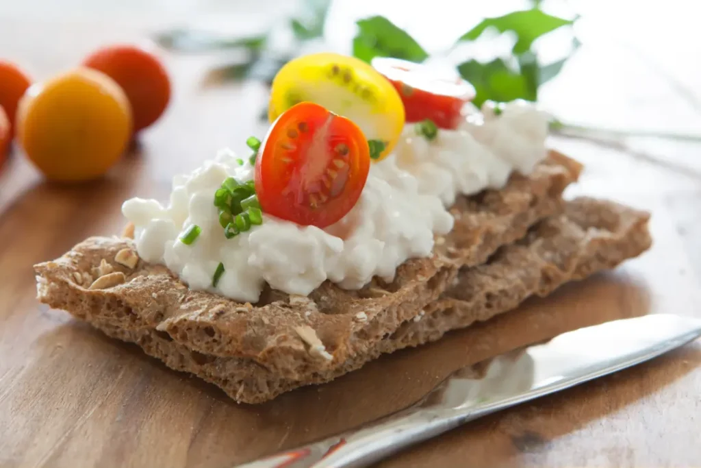 Whole-grain crackers with cottage cheese and cherry tomatoes.