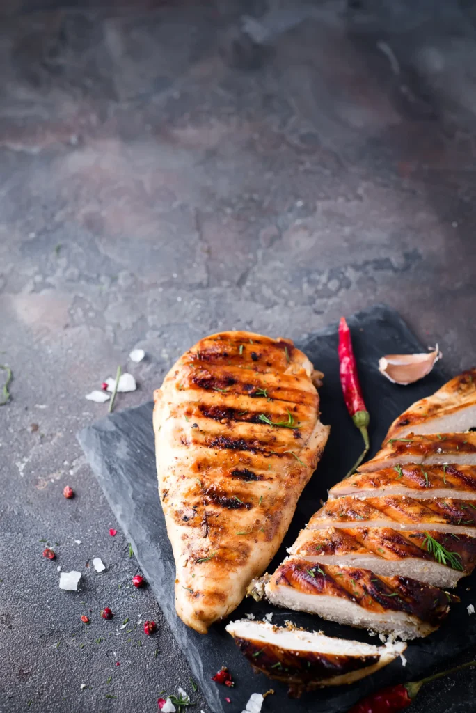 Sliced grilled chicken steak on a cutting board